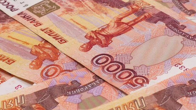 Russian paper money close up. Five-thousandth banknotes of the Bank of Russia as a monetary paper background. Banknotes 5000 rubles. Stack of Russian rubles banknotes.