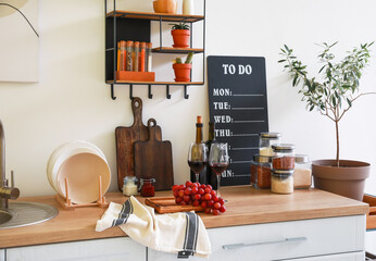 Counter with products and utensils in interior of modern kitchen