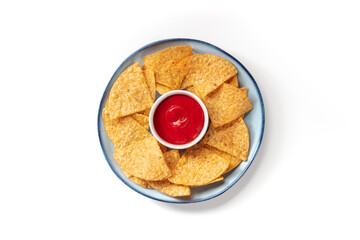 Nacho chips on a plate with a tomato salsa, shot from the top