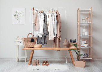 Rack with clothes in interior of modern room - obrazy, fototapety, plakaty