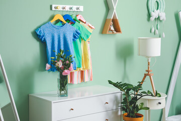 Rack with clothes in interior of children's room