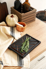 Fototapeta na wymiar Cutting boards with rosemary on kitchen counter