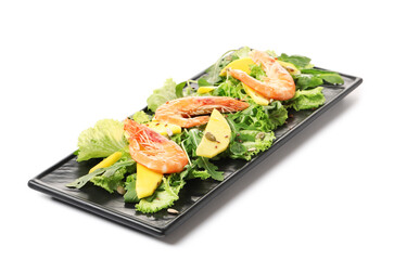 Plate of fresh mango salad with shrimps on white background