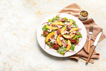 Plate of fresh mango salad on light background