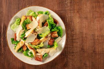 Caesar salad with chicken and Parmesan, overhead shot