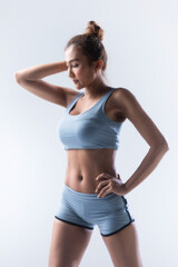 Close up image of strong young woman is posing perfect body slim and fit in studio on white background.