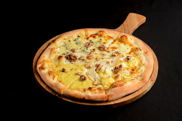 Hot delicous pizza with pear and blue cheese on wooden board. Vegetarian healthy food concept.