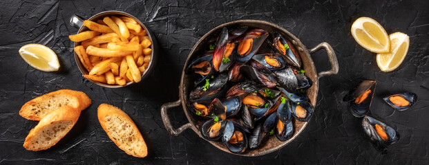 Mussels panorama with lemon, fries, and toasted bread