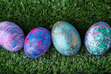 Colorful eggs with bright shiny gliter on grass