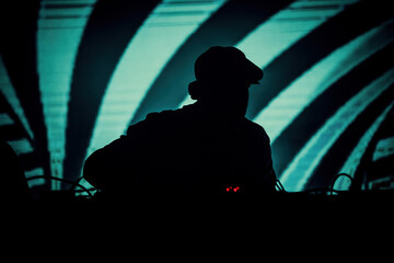 Silhouette of a DJ on a festival venue