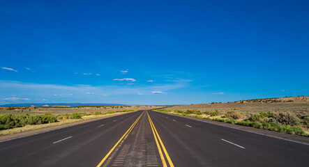 Fototapeta na wymiar Side view asphalt road on sunny summer day. Monument Valley Road.