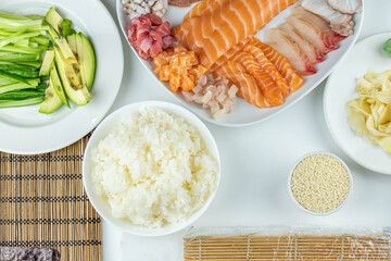 Close up of sushi chef hands preparing japanese food. Man cooking sushi at restaurant. Traditional asian seafood rolls on cutting board.