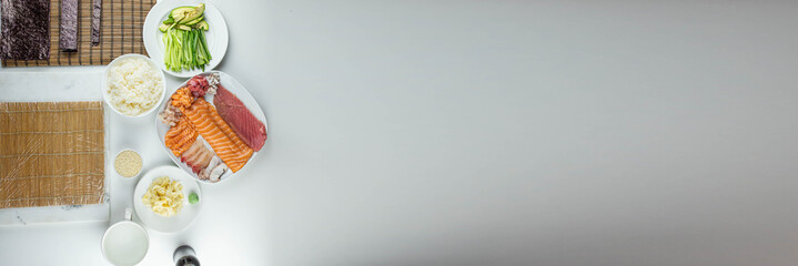 Close up of sushi chef hands preparing japanese food. Man cooking sushi at restaurant. Traditional asian seafood rolls on cutting board.