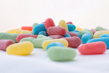 Close up of a pile of assorted colorful sour candies.