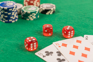 red dice on a green background in a casino