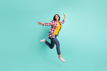 Full size profile side photo of charming young woman jump up walk empty space isolated on teal color background