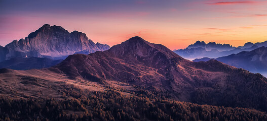 Amazing autumn scenery of Italian Dolomite Alps during sunset. Stunning panoramic view on majestic Monte Civetta mount colorful sky at sunset. Amazing nature background. Retro style. Instagram filter