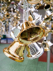 Lots of silver and gold bells for making merit at a Thai temple.