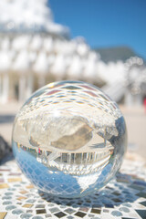 A crystal ball shot at a nameless temple statue on a beautiful area.
