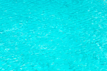 Ripple Water in swimming pool with blue tile floor background