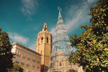 A street during the day in the city of Valencia with Christmas decorations