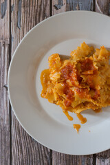 Homemade carrot pasta with flour and boiled carrots with vegetarian ragout.
