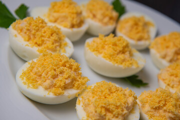 Stuffed eggs with crab crumbs, mayonnaise and parsley macro on a plate, High quality photo