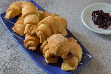 Crescent-shaped sweet shortcrust croissants filled with black cherry jam.