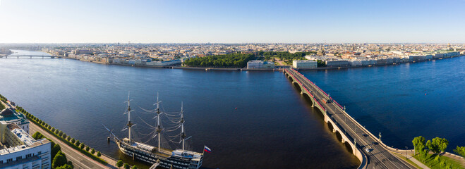 Troitsky Bridge and Palace Embankment along the Neva River. Peter and Paul Fortress on an early summer morning in clear weather in Saint Petersburg, Russia