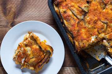Baked pasta with fried eggplant slices with vegetarian ragout.