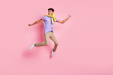 Fototapeta na wymiar Full size photo of young handsome happy positive smiling man jumping look copyspace isolated on pink color background