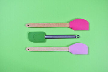 Kitchen tools for baking spoons brush on green background
