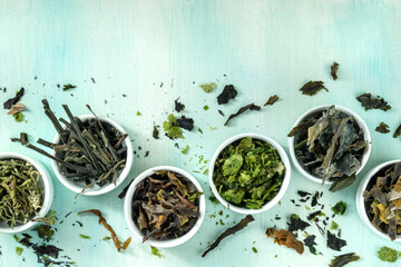Sea vegetables, edible seaweed, shot from above on a blue background
