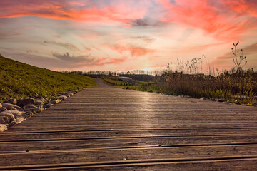 Fototapeta na wymiar Sunset hour on a wooden walkway