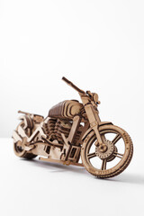 Wooden toy-motorcycle designer on a white background