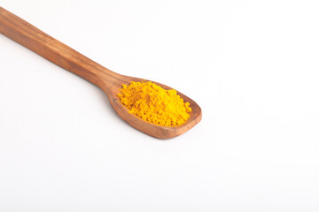 Turmeric in wooden spoon on white background.