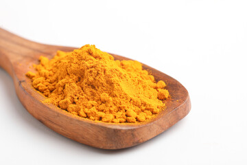 Turmeric in wooden spoon on white background.