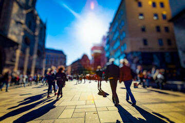 Crowd of anonymous people walking on busy city street