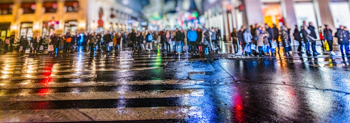 Crowd of anonymous people walking on busy city street