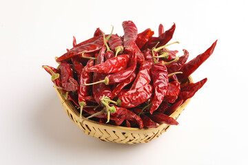 Dried red chilli and red chilli powder in glass bowl and wooden spoon on white background