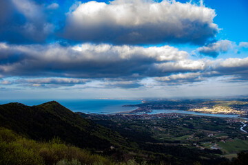Sea view with large beach and blue sky and mountains