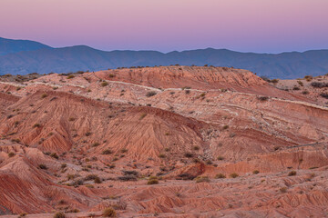 Landscape with badlands and hills in the foothills of the Andes mountain range in northwest Argentina just after sunset