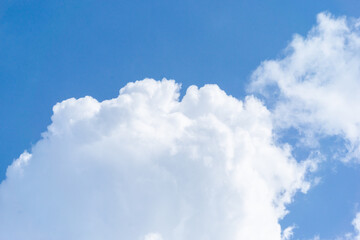Obraz premium Beautiful view of blue sky with clouds. Beautiful shapes, partly cloudy. Colorful sunset. Natural sky background texture, beautiful color. Bright landscape in the blue sky