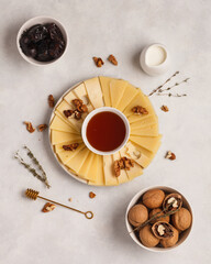 Cheese plate. Sliced cheese. Delicious sliced cheese and nuts
