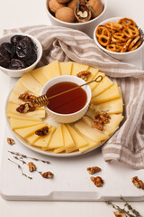 Cheese plate. Sliced cheese. Delicious sliced cheese and nuts