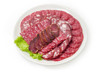 Sliced different cured and smoked sausages and meat on dish