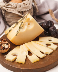 Cheese plate. Sliced cheese. Delicious sliced cheese and nuts