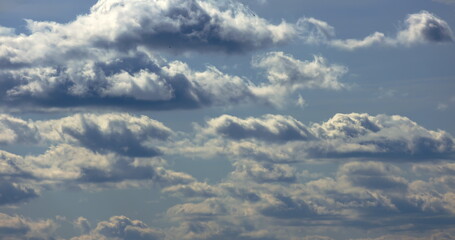 Flying through heavenly beautiful sunny cloudscape. Amazing timelapse of golden fluffy clouds moving softly on the sky and the sun shining through the clouds with beautiful rays and lens flare