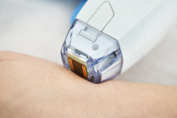 Woman receives laser and ultrasound treatment of face and body and hands in a medical sanatorium, skin rejuvenation concept
