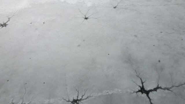 Close up drone view on ice on the lake or river. Cracking and melting ice on water.